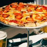 1/2 Priced Pizzas and $2 Tallboys